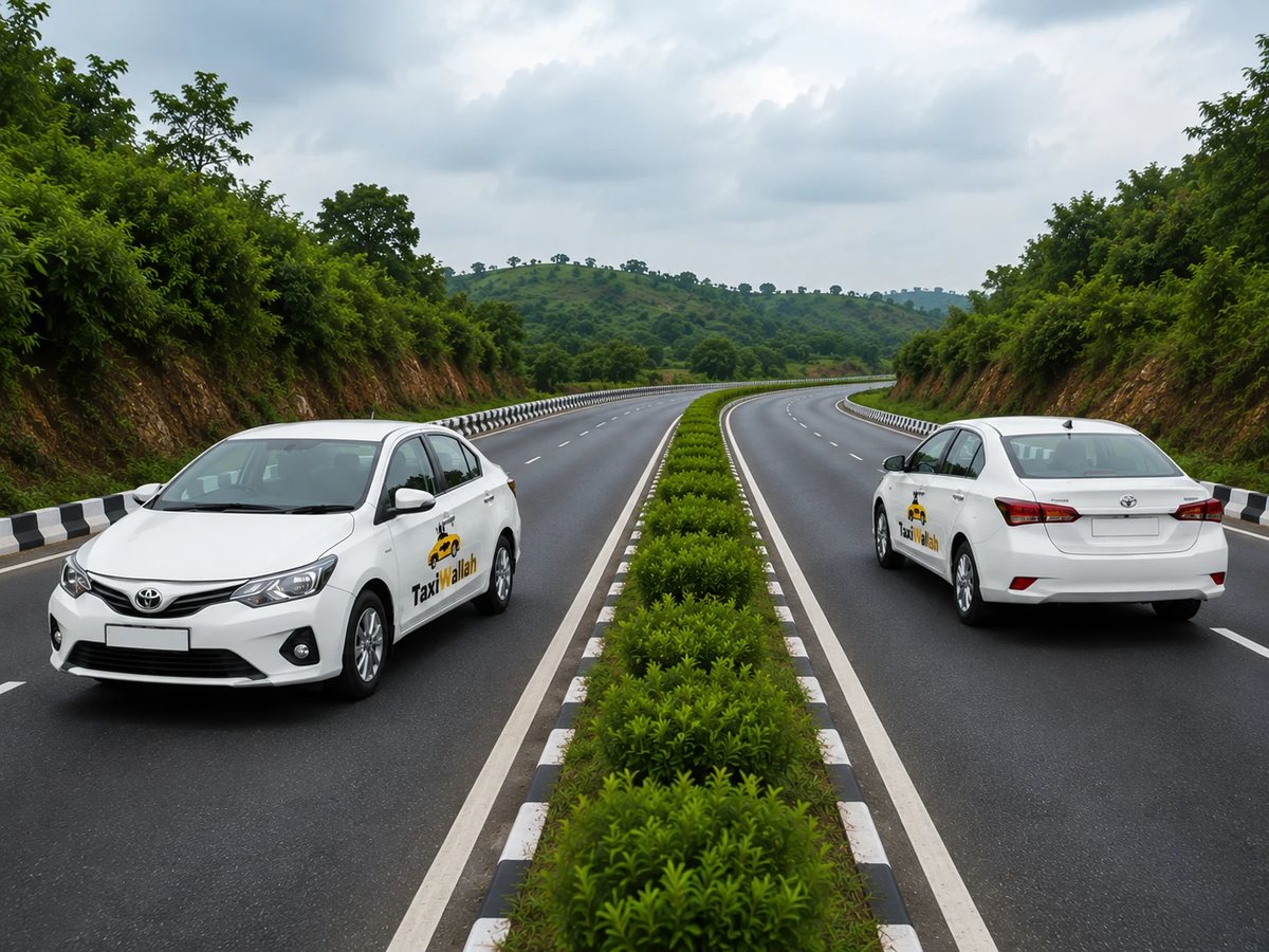 Two TaxiWallah cars on a divided highway, heading opposite directions